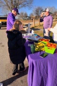 People at a merchandise table