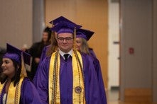 Student walking into recognition ceremony